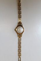 A 9ct yellow gold cased Accurist ladies cocktail watch on a 1/10 12ct rolled gold bracelet. At fault
