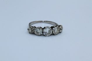 A five stone diamond ring in white metal, assessed as platinum. Set with five transitional cut
