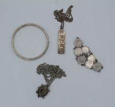 A group of silver jewellery comprising a silver jubilee ingot and chain, a sterling silver bangle, a