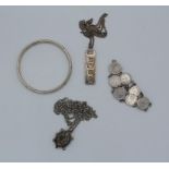 A group of silver jewellery comprising a silver jubilee ingot and chain, a sterling silver bangle, a