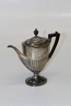 Goldsmiths and Silversmiths Co Ltd, an Edwardian silver coffee pot, of demi- reeded Neo Classical