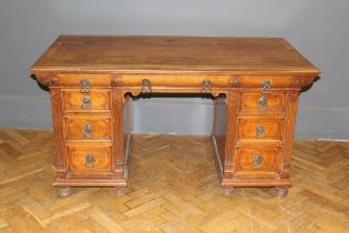 A late 19th century Gillows oak partner's desk, the rectangular top with a moulded edge, over a