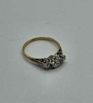 A diamond three stone ring. The principal stone is an estimated 0.33 carat Old European cut diamond.