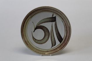 Alan Caiger- Smith 1930 -2020 British  A pale ground pottery charger having a monogram in brown