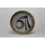Alan Caiger- Smith 1930 -2020 British  A pale ground pottery charger having a monogram in brown