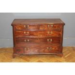 A mahogany chest of drawers, having two short and three long drawers fitted with brass handles,