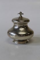 A Dutch sterling silver circular baluster form tea caddy, with button fastener, hinged lid and knopp