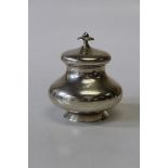 A Dutch sterling silver circular baluster form tea caddy, with button fastener, hinged lid and knopp