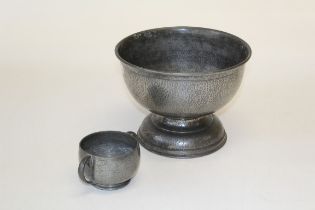 A large hammered pewter Tudric hemispheric stemmed bowl, stamped, diameter 23cm and a smaller