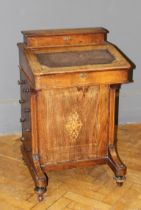 A late Victorian walnut, boxwood inlaid and strung Davenport desk, fitted four side drawers, on