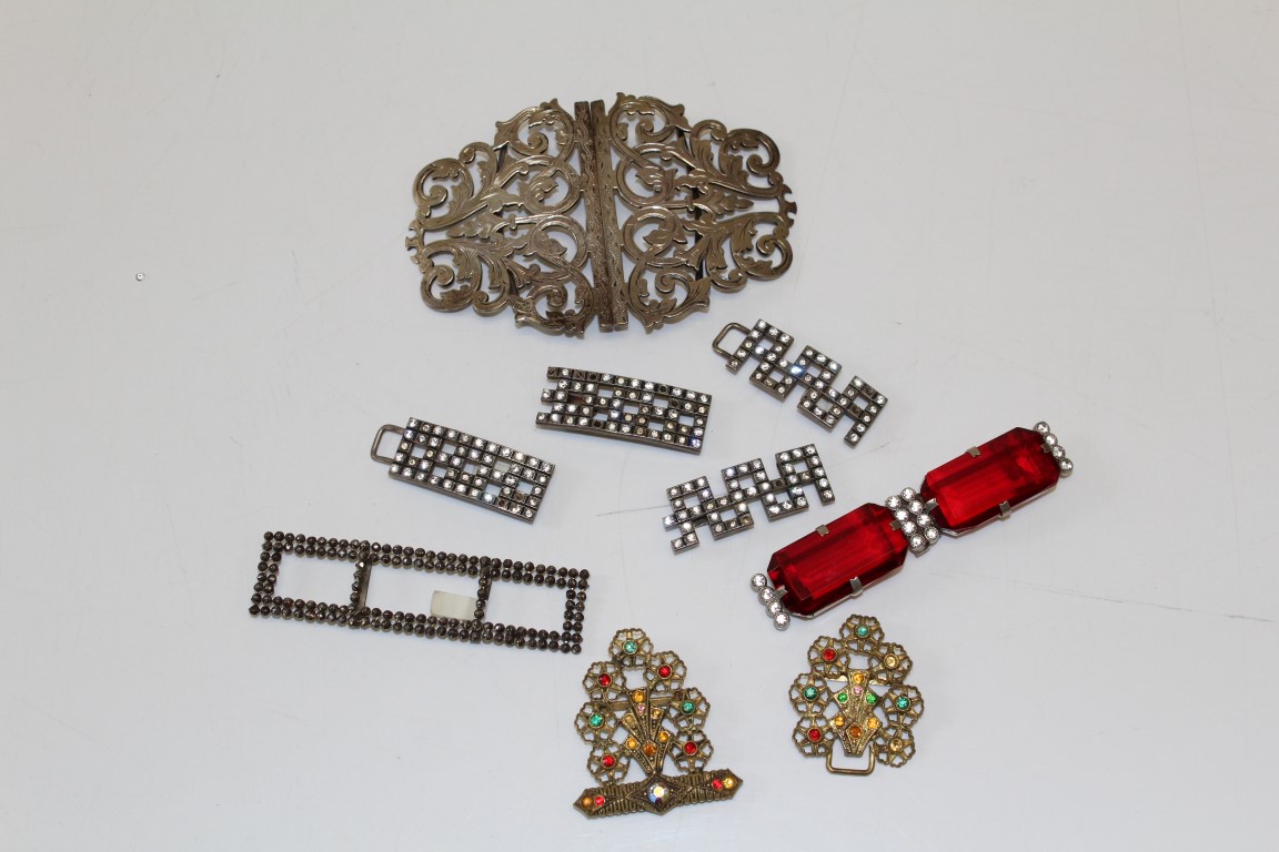 A sterling silver nurses belt buckle, together with a collection of five antique and vintage belt