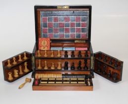 A late Victorian/ Edwardian walnut games compendium. The hinged top and front revealing a well