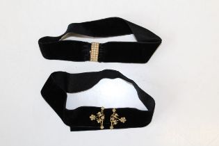 A seed pearl studded rectangular box clasp on yellow metal affixed to a velvet ribbon as a choker,