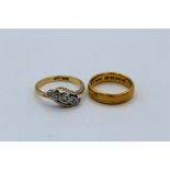 An early 20th century five stone diamond ring. Stamped "18ct +Plat" along with a 22ct gold band