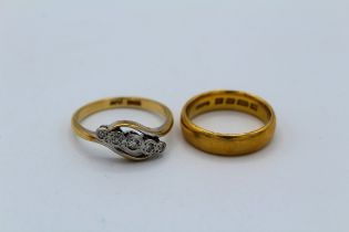 An early 20th century five stone diamond ring. Stamped "18ct +Plat" along with a 22ct gold band
