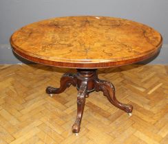 A Victorian walnut and inlaid breakfast table, the snap top raised on quadruple swept legs, width