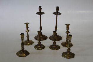 A pair of 19th century mahogany and brass mounted large candlesticks with twist and fluted