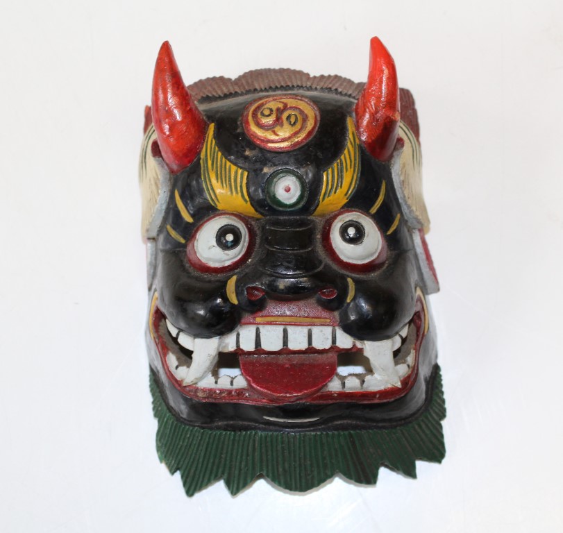 A 20th century Mahakala type painted carved wood mask. 17 x 12cm