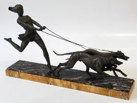 An Art Deco spelter group of good size, modelled as a young woman, running with a pair of