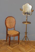 An early 20th century later gilt painted shaving stand with twin candle sconces and adjustable