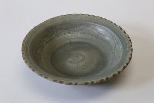 A Celadon ground pottery charger with incised decoration from The Royal Nanhai Cargo, diameter 30cm