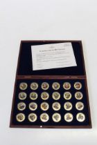 Set of twenty four gold plated commemorative coins of world wide music composers in wooden display