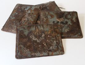 A set of six embossed and polychrome decorated leather squab cushions, probably made from 18th/ 19th
