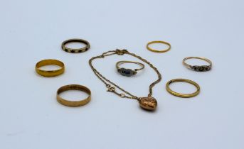 A collection of gold jewellery: two 22ct gold band rings; two 18ct gold band rings; a gem set
