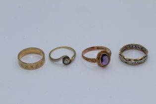 A collection of four precious metal rings. Featuring a diamond solitaire, bezel set with a 3mm old