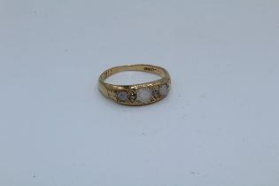 An opal and diamond set 18ct gold half hoop ring. Size M1/2. Gross weight approximately 3.17 grams.