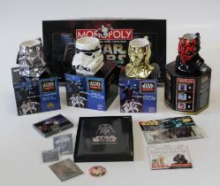 A collection of Stars Wars memorabilia including a Monopoly game, posters, videos and various