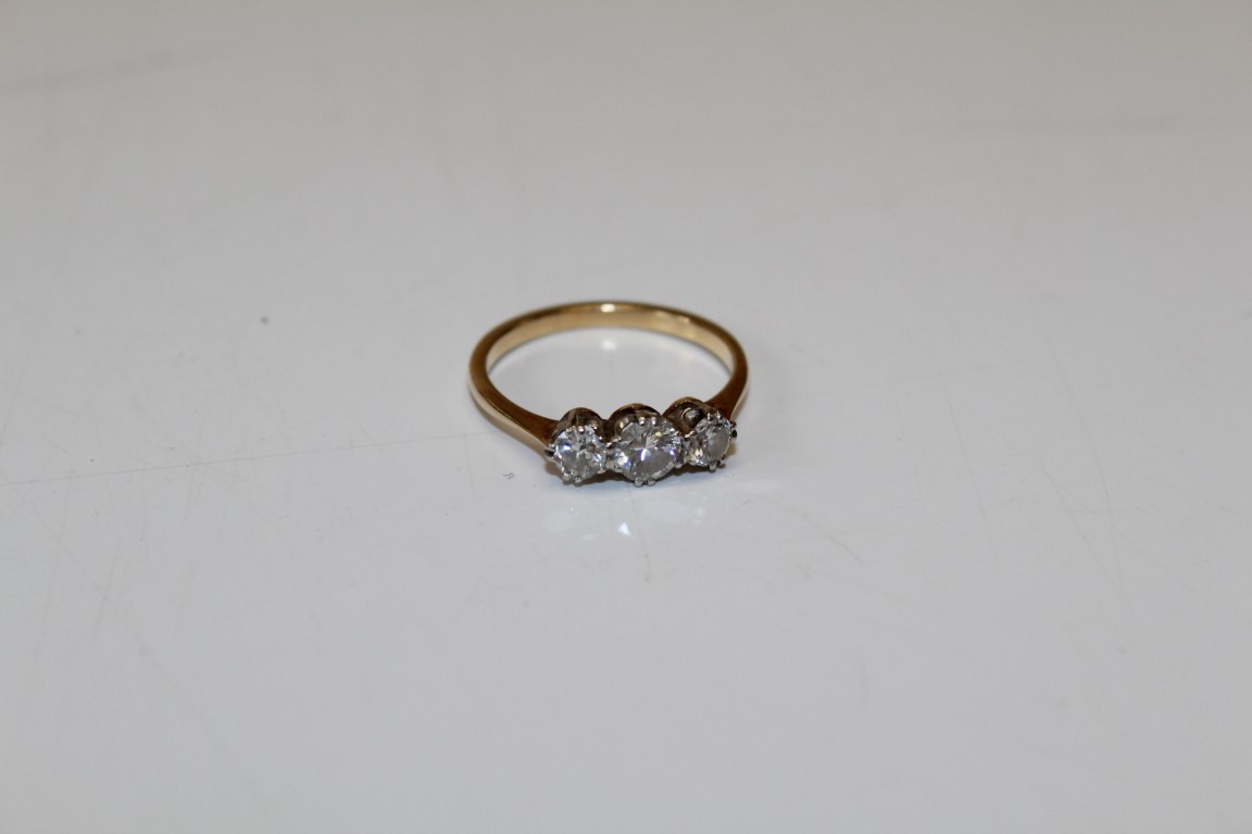 A three stone diamond ring, featuring a central round brilliant cut stone of 0.25 carats and two 0. - Image 2 of 2