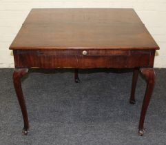 A George III ' red walnut' supper table, the rectangular folding top with twin gate support, over