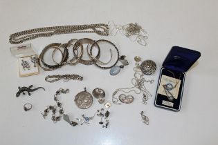 A collection of silver jewellery to include a Robert Allison brooch, chains, bangles and other