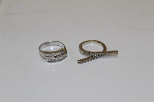 Two diamond set rings. Featuring a crossover style ring set with baguette cut diamonds, in