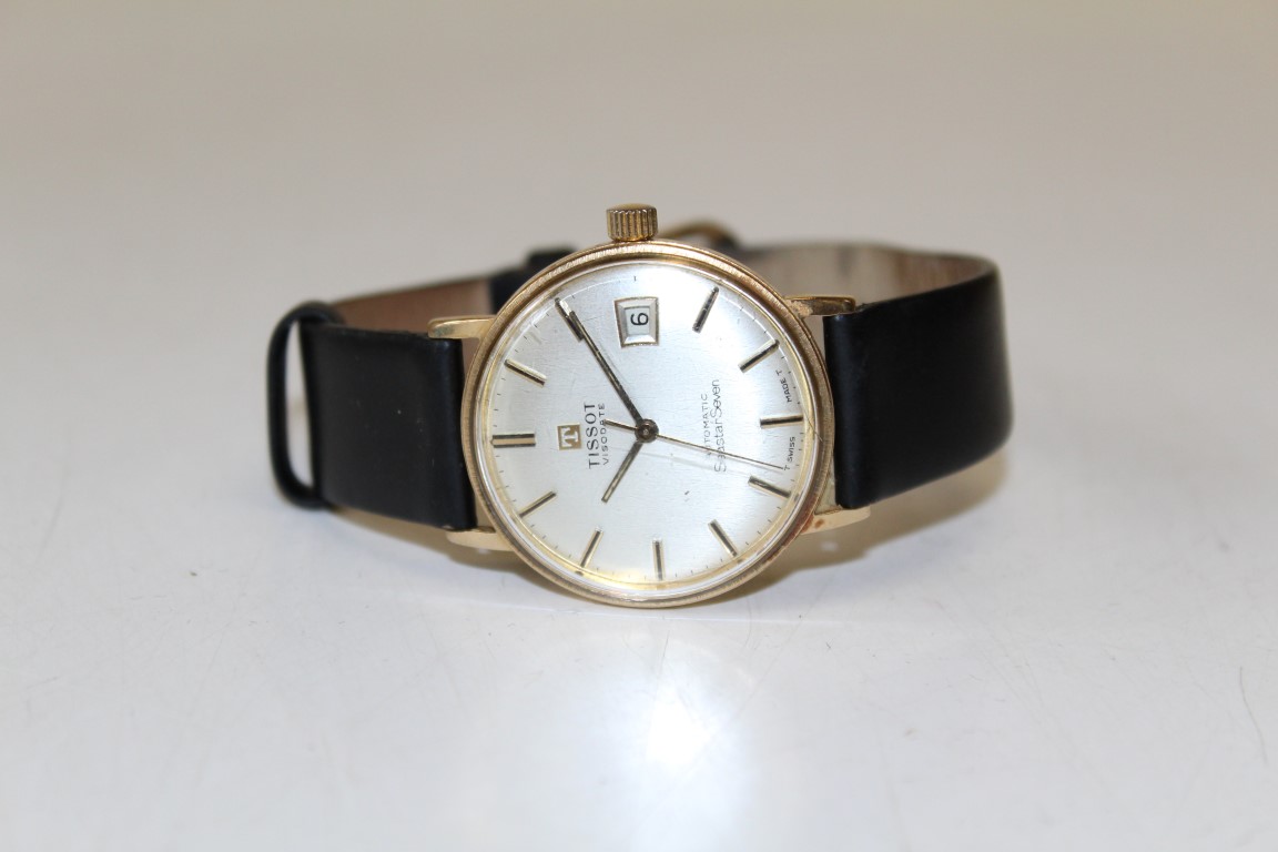 A 9ct gold Tissot Seastar Seven Automatic wristwatch. Featuring a champagne dial with gold baton