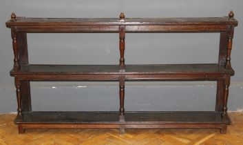 A set of large oak hanging shelves the tiers supported by ring turned and block supports, late