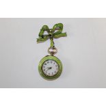 An Edwardian green enamel gilt silver ladies brooch watch. The ornate watch is suspended from a gilt