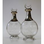 A pair of Victorian silver mounted Hukin and Heath cut glass small decanters with crescent stoppers,