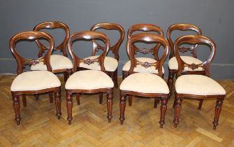 A set of six William IV style mahogany balloon back dining chairs, each with serpentine front