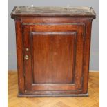A large oak food/ spice cupboard, the moulded top over a fielded panel door enclosing drawers and