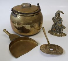 Four various items of brassware comprising a large pan and cover, dustpan, a skimmer and a Punch