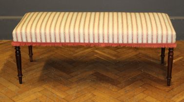 A 20th century Victorian style long stool with stripe upholstered seat, raised on turned tapering