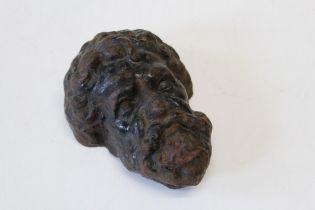 A 19th century cast iron Bacchus mask, probably an element of door furniture, 17cm