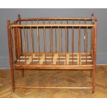 George Blake and Co, Oxford, an Edwardian beech collapsible cot/playpen with stick splats raised