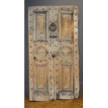 A large early 19th century pine panel door, having four fielded panels and a pair of roundel panels,