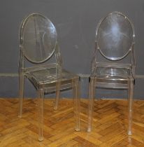 A pair of Perspex ghost chairs having oval backs