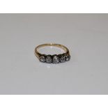 An early 20th century five stone diamond half hoop ring. Stamped "18ct" to the shank and testing