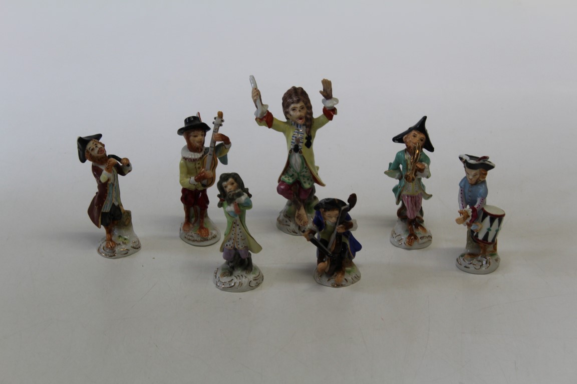 A set of seven Dresden style porcelain figures after the 18th century Meissen monkey band
