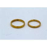 Two 22 carat gold band rings, size O and size K. Gross weight approximately 5.96 grams